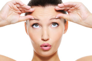 what age is appropriate to start Botox - woman showing forehead wrinkles
