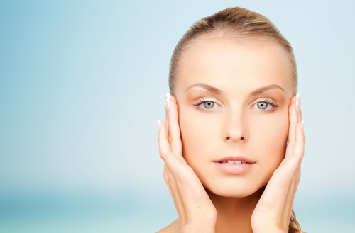 young woman touching her youthful skin shaped by Hinsdale laser skin tightening