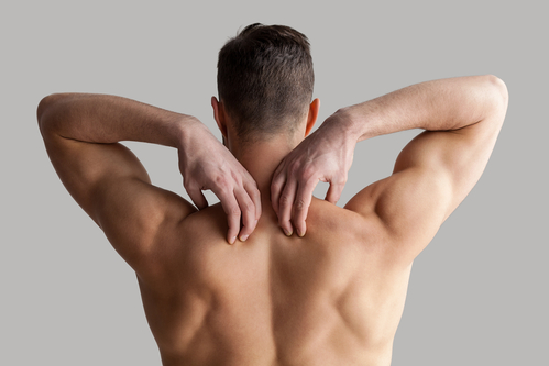 man touching his smooth back thankful for Hinsdale laser hair removal
