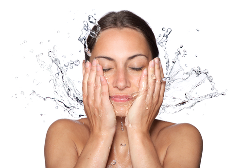 woman washing face following healthy Hinsdale skincare tips for 2017