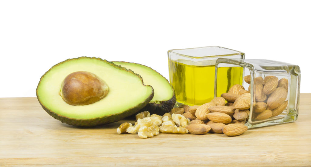 avocado next to almonds and olive oil